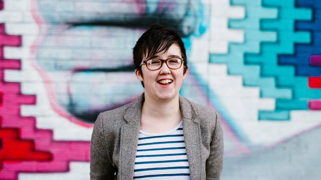 Journalist McKee smiles outside the Sunflower Pub in Belfast 