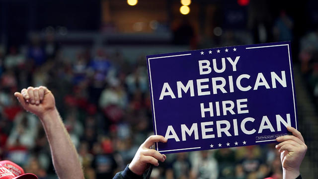 Supporters of U.S. President Donald Trump hold up signs as they wait for him to speak at a campaign rally in Grand Rapids, Michigan 