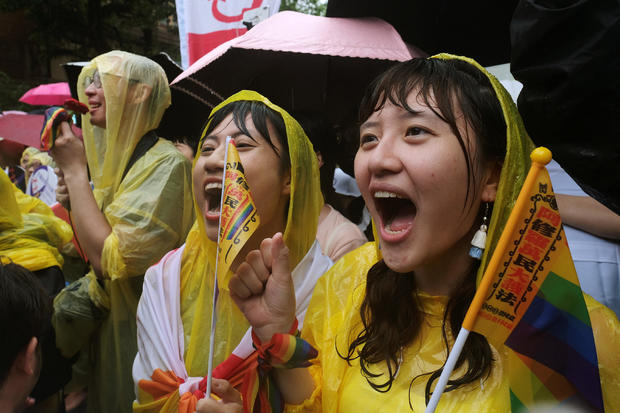 Same-sex marriage supporters shout during a parliament vote on three draft bills of a same-sex marriage law, outside the Legislative Yuan in Taipei 