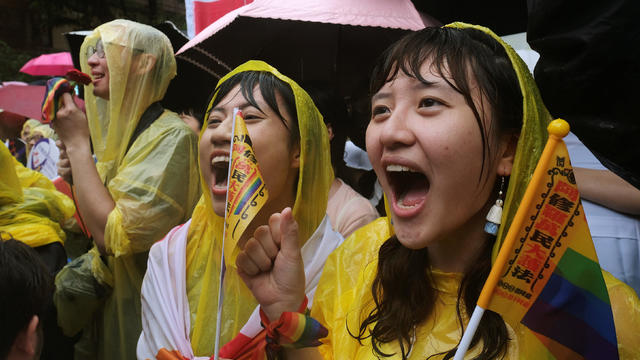 Same-sex marriage supporters shout during a parliament vote on three draft bills of a same-sex marriage law, outside the Legislative Yuan in Taipei 