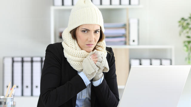 Angry businesswoman having cold at office 
