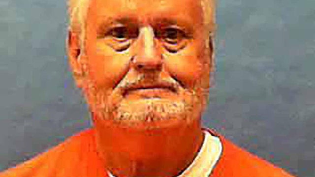 Florida death row inmate Bobby Joe Long, convicted of the 1984 murders of eight women, poses for a prison photo at Florida State Prison in Raiford 