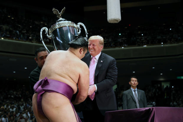 U.S. President Donald Trump presents the President's Cup to wrestler Asanoyama, the winner of the Summer Grand Sumo Tournament at Ryogoku Kokigikan Sumo Hall in Tokyo 