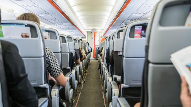 airplane with passengers on seats waiting to take off 