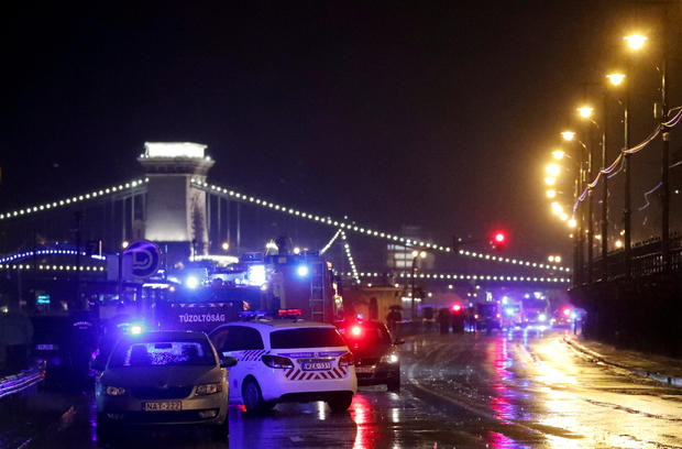 Police and fire brigade vehicles are seen on the Danube bank after tourist boat capsized on the river in Budapest 