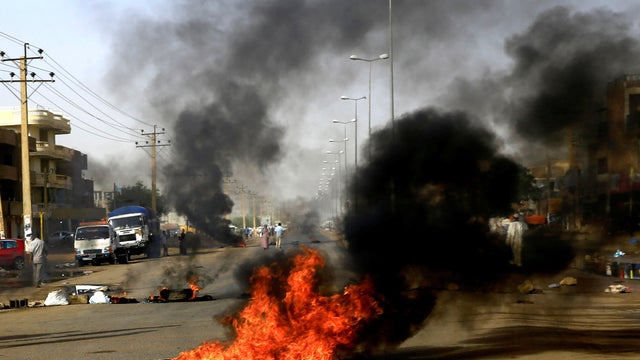 Sudanese protesters use burning tyres to erect a barricade on a street, demanding that the country's Transitional Military Council hand over power to civilians, in Khartoum 