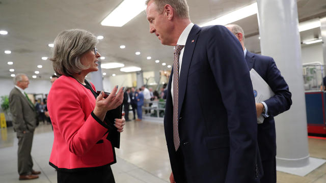U.S. Senator Ernst speaks with acting Secretary of Defense Shanahan in the subway system at the U.S. Capitol in Washington 
