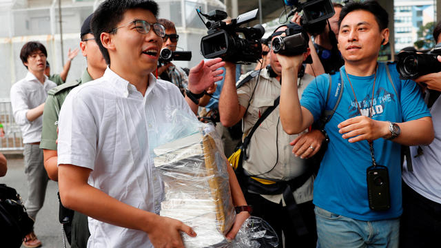 Former student leader Joshua Wong walks out from prison after being jailed for his role in Occupy Central movement, also known as "Umbrella Movement", in Hong Kong 