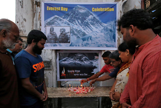 People light candles during a prayer service for those who died on Mount Everest during expeditions as they celebrate Everest Day in Kolkata 