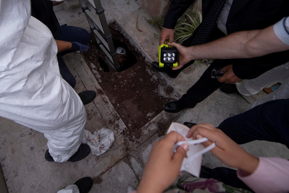 People open a tomb in a cemetery on the Vatican's grounds 