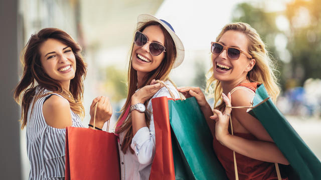 Beautiful woman with shopping bags in the city-sale, shopping, tourism and happy people concept 