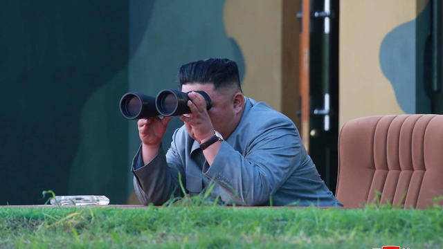 North Korean leader Kim Jong Un watches the test-fire of two short-range ballistic missiles 