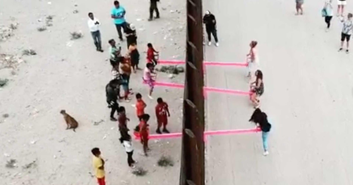 Pink seesaws at border wall Artist installs seesaws at Trump border