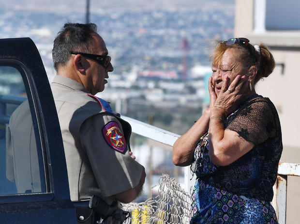 Virginia Chacon reacts as she tells her survival story to a police officer outside the Walmart where a shooting left 20 people dead in El Paso, Texas, on Aug. 4, 2019. 