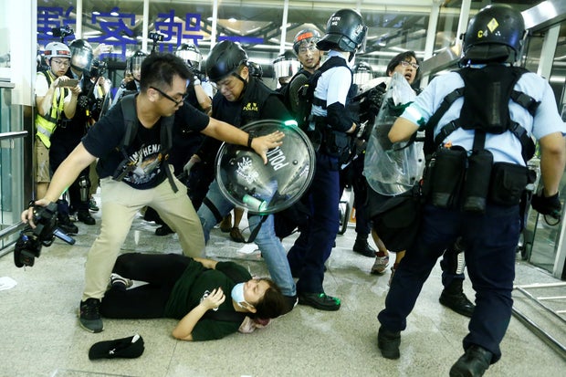 Police clash with anti-government protesters at the airport in Hong Kong,