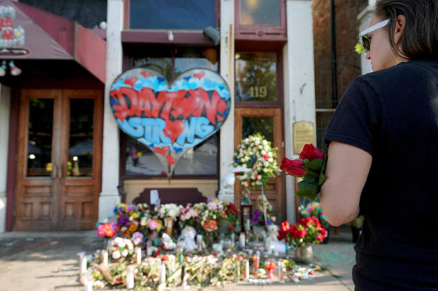FILE PHOTO: A Oregon District resident stands at a memorial for those killed during Sunday morning's a mass shooting in Dayton 