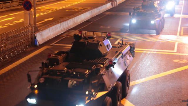 Military vehicles of the Chinese People's Liberation Army (PLA) pass Huanggang Port for a routine troop rotation in Hong Kong 