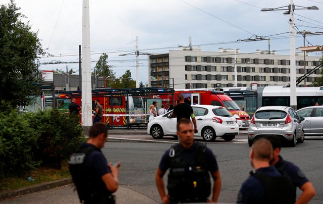 French police secure the area after one person was found dead and six others wounded in a suspected knife attack in Villeurbanne, near Lyon 