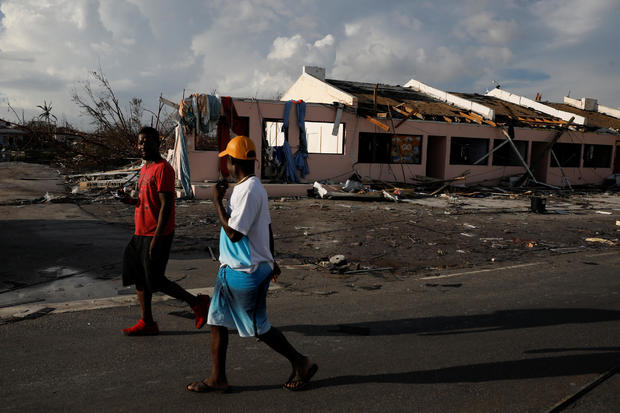Men walk past a destroyed shopping mall after hurricane Dorian hit the Abaco Islands in Marsh Harbour 