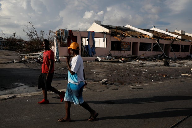 Men walk past a destroyed shopping mall after hurricane Dorian hit the Abaco Islands in Marsh Harbour