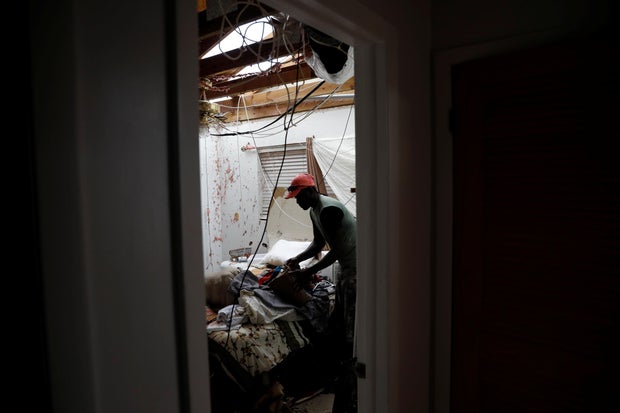 A man packs his clothes at this home after hurricane Dorian hit the Abaco Islands in Marsh Harbour