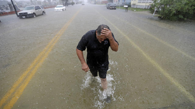 Angel Marshman wades through floodwaters from Tropical Depression Imelda after trying to start his flooded car September 18, 2019, in Galveston, Texas. 
