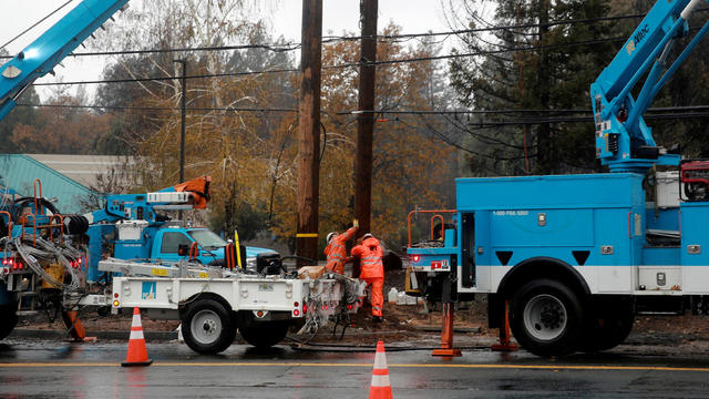 Pacific Gas & Electric works on power lines to repair damage caused by the Camp Fire in Paradise, California, November 21, 2018. 