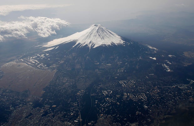 Mount Fuji in Japan is covered with snow from an airplane
