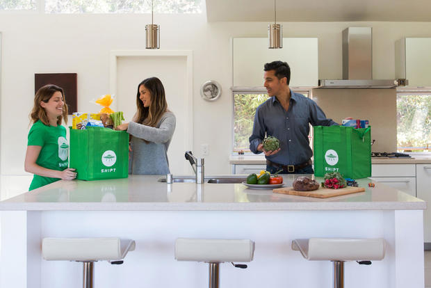 A family unpacking a Shipt delivery in their kitchen 
