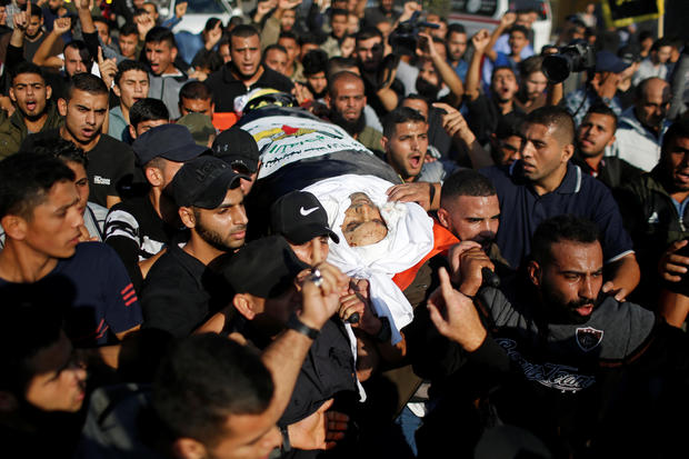 Mourners carry the body of Palestinian Islamic Jihad field commander Baha Abu Al-Atta during his funeral in Gaza City 