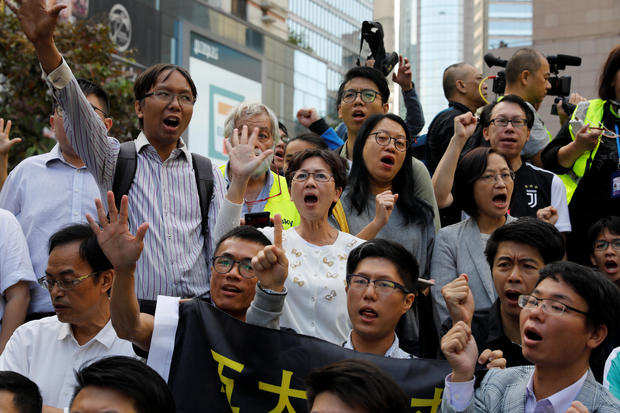 Pro-democratic winning candidates gather outside the campus of the Polytechnic University (PolyU) in Hong Kong 