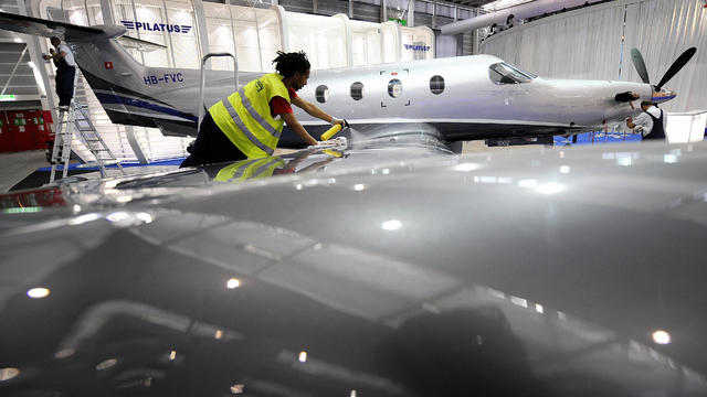 An employee cleans a PC-12 model of the 