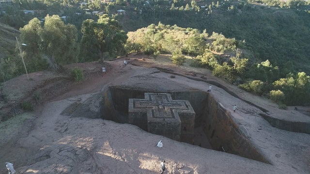 Priest in Bet Danaghel Church holding the Cross of King Lalibela. The  rock-hewn churches of Lalibela make it one of the greatest  Religio-Historical sites not only in Africa but in the Christian