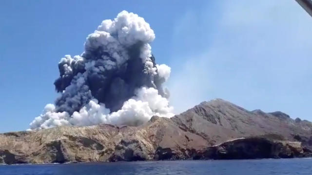 Smoke from the volcanic eruption of Whakaari, also known as White Island, is pictured from a boat 