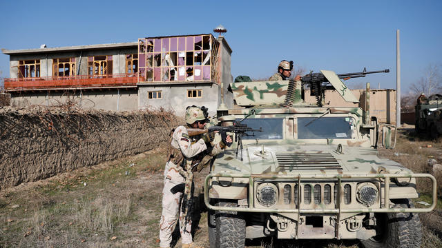 Afghan security forces take position at the site of an attack in a U.S. military air base in Bagram 