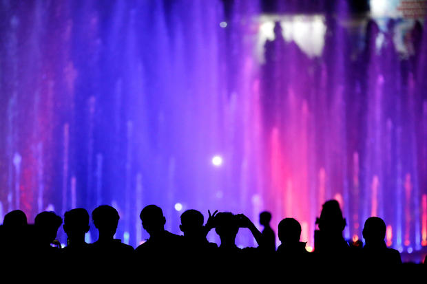 People watch a water show at the National Monument complex during New Year's Eve celebrations in Jakarta, Indonesia, December 31, 2019. 