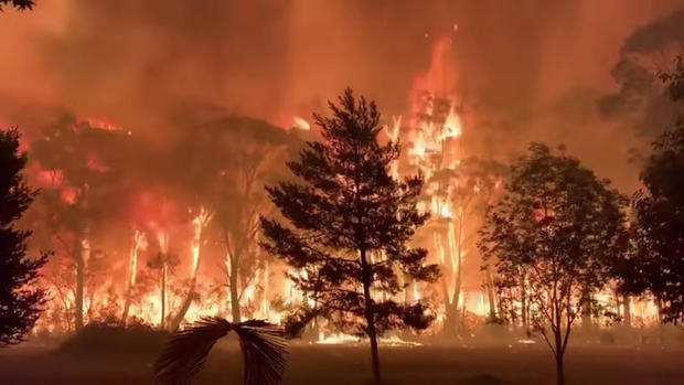 A fire blazes across bush as seen from Mount Tomah in New South Wales 
