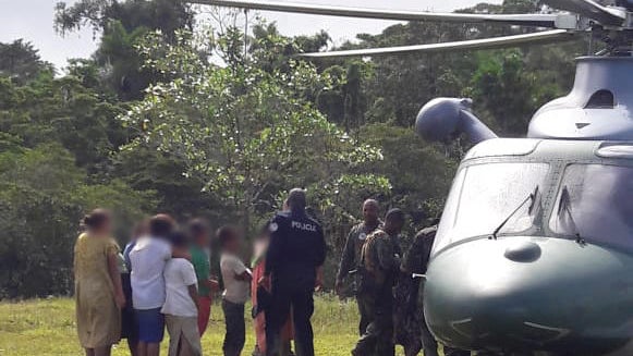 Police officer approaches persons allegedly responsible for the deaths of seven people, in Bocas Del Toro 