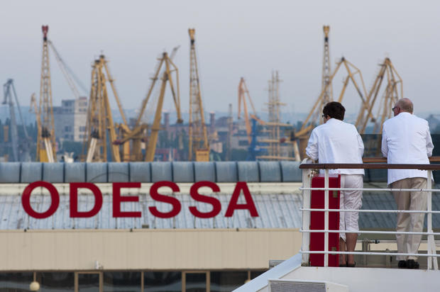 Passengers of a cruise ship look out at the port of Odessa, Ukraine 