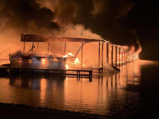 A row of boats is engulfed in flames after catching fire at a marina in Scottsboro, Alabama, January 27, 2020. 