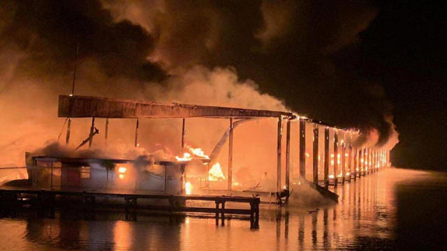 A row of boats is engulfed in flames after catching fire at a marina in Scottsboro, Alabama, January 27, 2020. 