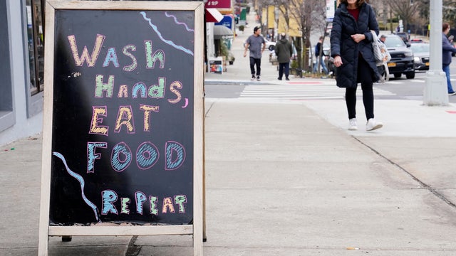 A restaurant displays a sign around the corner from SAR High School, which has been shut down due to Coronavirus, in the Bronx borough of New York City 