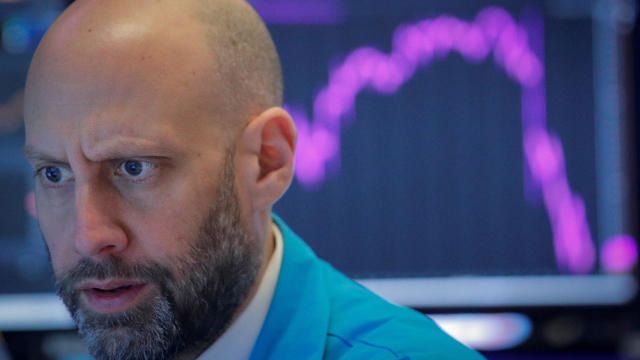 FILE PHOTO: A trader work on the floor at the NYSE in New York on Feb 27, 2020 