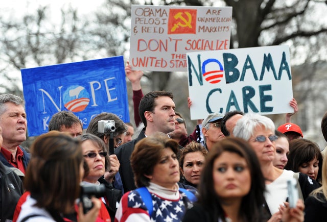 Participants display placards during a d 