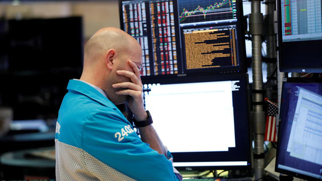 A trader reacts as he works on the floor of the New York Stock Exchange (NYSE) in New York City 