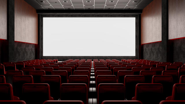 Empty Movie Theater with Red Seats and Blank Screen 