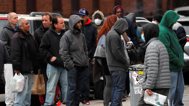 Homeless and other needy people crowd together as they wait for a free meal outside The Bowery Mission on the lower east side of Manhattan during the outbreak of the coronavirus disease (COVID-19) in New York 