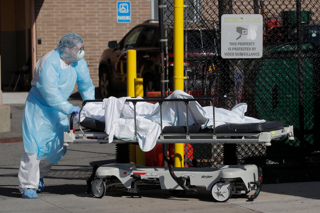 Healthcare worker wheels body of deceased person from Wyckoff Heights Medical Center during outbreak of coronavirus disease (COVID-19) in New York 