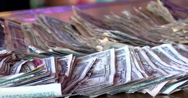 Bar owner removes dollar bills from walls to pay staff during