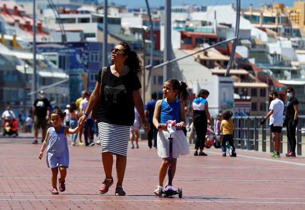 Family members walk at promenade of Las Canteras beach after restrictions were partially lifted for children for the first time in six weeks, following the coronavirus disease (COVID-19) outbreak on the island of Gran Canaria 